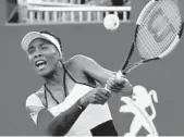  ?? CHARLES TRAINOR JR./MIAMI HERALD ?? Venus Williams returns a ball hit by Daria Kasatkina on the grandstand court on Sundayat the Miami Open.