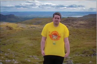  ??  ?? Chairman of Sligo Darkness into LIght Corey Whyte wearing his ‘Darkness into LIght T-shrit’ on the top of Benbulben last week ahead of the Darkness into Light walk through Sligo town last Saturday morning.