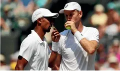  ??  ?? Doubles team-mates Raven Klaasen and Michael Venus talk tactics on court during their Wimbledon semifinal. GETTY IMAGES