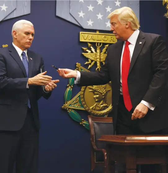  ?? (Reuters) ?? PRESIDENT DONALD TRUMP with Vice President Mike Pence, after signing an executive order banning immigrants from seven countries for 90 days from entering the United States.