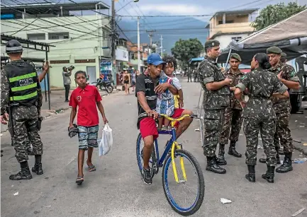  ?? PHOTO: WASHINGTON POST ?? In a government-ordered campaign that began in February, soldiers were sent to fight crime in Rio de Janeiro’s favelas, including Vila Kennedy, seen here. Violencewe­ary residents of the shantytown hailed the move.
