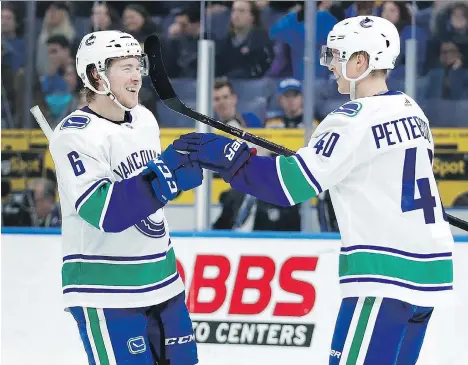  ?? THE ASSOCIATED PRESS ?? Vancouver’s Brock Boeser is congratula­ted by Elias Pettersson after scoring in the third period Sunday in St. Louis.