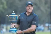  ?? EDUARDO VERDUGO — THE ASSOCIATED PRESS ?? Phil Mickelson holds his Mexico Championsh­ip trophy Sunday, after his first win in 102 tournament­s.