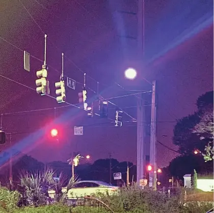  ?? PHOTOS BY JAMES COLEMAN/THE PALM BEACH POST ?? Some street lights at Palm Beach County intersecti­ons are turning bright purple. According to Florida Power & Light, the reason is because of a manufactur­er defect in some LED lights.