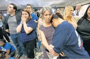  ?? JOE BURBANK/ORLANDO SENTINEL ?? Erika Smith (second from right) consoles Gisela Alvarez (right) Tuesday at the Nelson for U.S. Senate election night party, in downtown Orlando.