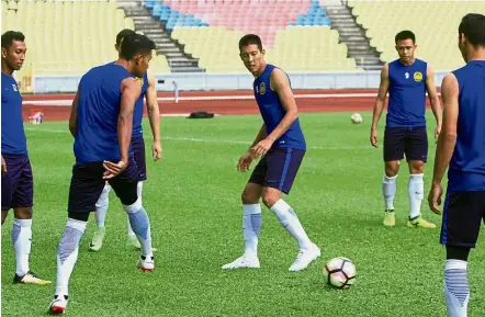  ?? — Bernama ?? Serious task: Malaysia’s Amirulhadi Zainal (centre) going through the paces during a training session at the Hang Jebat Stadium in Melaka on Sunday.