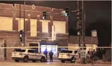  ??  ?? Authoritie­s investigat­e after a man was shot by Chicago Police outside of a liquor store late Friday in Englewood.
| DANIEL BROWN/ SUN- TIMES