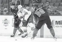  ?? CHRIS O’MEARA/AP ?? Panthers left wing Mason Marchment, center, battles with the Lightning’s Barclay Goodrow, left, and Mikhail Sergachev.