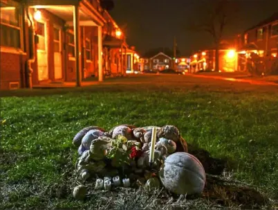  ??  ?? Candles, flowers and toys adorn a makeshift memorial for Kennir Parr of Swissvale, at Hawkins Village in Rankin. Kennir, 14, was shot and killed on July 4, 2016. His murder remains unsolved.