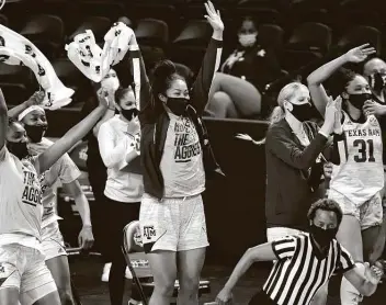  ?? Photos by Sean Rayford / Associated Press ?? Texas A&M center Kenyal Perry, from left, Sahara Jones, Ella Tofaeono, Anna Dreimane and N’dea Jones celebrate a basket during the second half against LSU. Five players scored in double figures for the Aggies.