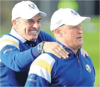  ??  ?? Ryder Cup captain Paul McGinley celebrates after Jamie Donaldson (right) had sealed victory for Europe at Gleneagles in 2014.