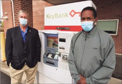  ?? Brian A. Pounds / Hearst Connecticu­t Media ?? Leon Standly, left, and Kenneth Moss at the Key Bank on Canal Street in Stamford on Oct. 12. Standly, a Pacific House Shelter resident, helped Moss get a hassle-free account at the bank after developing a relationsh­ip with a bank manager.