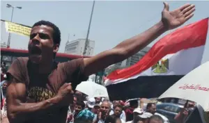  ?? (Amr Abdallah Dalsh/reuters) ?? A MUSLIM BROTHERHOO­D supporter in Cairo’s Tahrir Square shouts slogans against the military council yesterday.