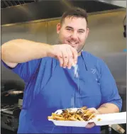  ?? DAVE FARIES ?? John Arslanian is one of the chefs at Fresh & Bangin’ Eatery, a restaurant in Lucerne that has helped inspire a culinary revolution in Lake County.