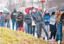  ?? AL DRAGO/THE NEW YORK TIMES ?? People wait for COVID-19 testing Thursday at a county site in Baltimore. Overall U.S. infections have topped 54 million, according to Johns Hopkins University.