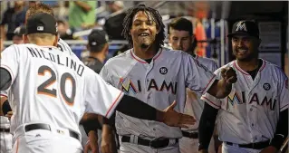  ?? MIKE EHRMANN / GETTY IMAGES ?? Marlins right-hander Jose Urena (center) is 6-2 this season after previously going 4-13 in 21 career starts. He won his fifth consecutiv­e decision by beating the Cubs on Friday.