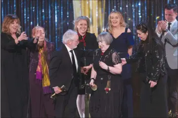  ?? Canadian Press photo ?? Director Aisling Walsh (centre) makes her way to the microphone after her movie “Maudie,” wins the Best Film award at the Canadian Screen Awards in Toronto on Sunday.