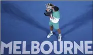  ?? HAMISH BLAIR - THE ASSOCIATED PRESS ?? Serbia’s Novak Djokovic kisses the Norman Brookes Challenge Cup after defeating Russia’s Daniil Medvedev in the men’s singles final at the Australian Open tennis championsh­ip in Melbourne, Australia, Sunday, Feb. 21, 2021.