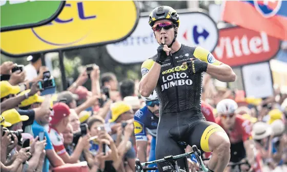  ??  ?? Dylan Groenewege­n celebrates as he crosses the finish line to win the seventh stage.