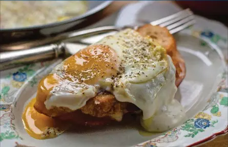  ?? CONTRIBUTE­D BY HENRI HOLLIS ?? The classic croque madame, a grilled cheese topped with bechamel and a sunny-side-up egg.