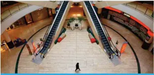  ??  ?? LVERKUSEN: A person is seen inside an empty shopping mall during a partial lockdown in Leverkusen, Germany as the spread of the coronaviru­s disease (COVID-19) continues. — Reuters