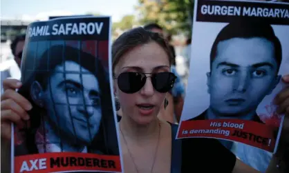  ?? Photograph: Petros Karadjias/AP ?? An Armenian protester holds pictures of Ramil Safarov, left, and Gurgen Margaryan during a demonstrat­ion outside the Hungarian embassy in Nicosia, Cyprus, in 2012.