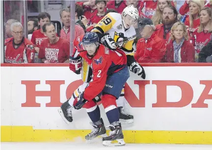  ?? NICK WASS/THE ASSOCIATED PRESS ?? Pittsburgh Penguins centre Jake Guentzel, seen tangling with Washington Capitals defenceman Matt Niskanen during Game 2 in Washington, D.C., on Saturday, has been rising to every challenge since his youth, his father and his university coach say.