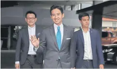  ?? VARUTH HIRUAYATHE­B ?? Mr Pita, centre, gestures as he departs a press conference held at the Move Forward Party’s headquarte­rs on May 23.