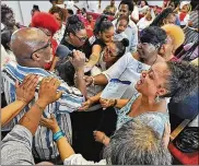  ??  ?? Rev. James Michael Martin is greeted by church members during his return to preaching at Christ Is The Answer Ministries in Akron on Sunday, Aug. 5, 2018.