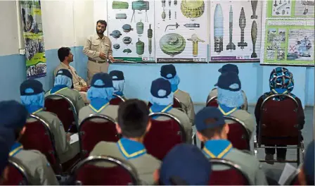 ?? — AFP ?? rapt attention: Afghan Scouts listening to a deminer as they attend a class at the Scouts training centre in Kabul.