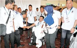  ??  ?? Azis (seated in a wheelchair)attending the joint opening of the Wira, Wanita and Wirawati movements yesterday. - Bernama photo