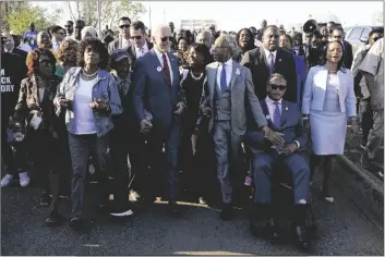  ?? PATRICK SEMANSKY/AP D-ala. (center), and the Rev. ?? PRESIDENT JOE BIDEN TALKS WITH REP. TERRI SEWELL,
Al Sharpton after walking across the Edmund Pettus Bridge in Selma, Ala., on Sunday to commemorat­e the 58th anniversar­y of “Bloody Sunday,” a landmark event of the civil rights movement. Sharpton holds hands with the Rev. Jesse Jackson at right.