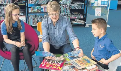  ?? Picture: Marieke McBean. ?? Ellie MacAdam, 8, from Pitlochry, Alison Stewart, reading, from Aberfeldy, and Andrei Odela, 7, from Pitlochry at reading sessions in the library.