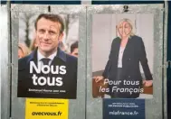  ?? ?? Defaced presidenti­al campaign posters of French President Emmanuel Macron and far-right presidenti­al candidate Marine Le Pen, on Saturday in Salies de Bearn, southweste­rn France.