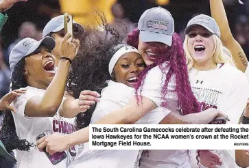  ?? ReuTeRS ?? The South Carolina Gamecocks celebrate after defeating the Iowa Hawkeyes for the NCAA women’s crown at the Rocket Mortgage Field House.