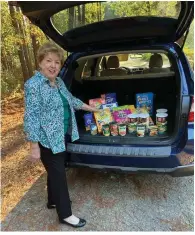  ?? (Special to The Commercial) ?? Kay Cromwell, community service chairman with the Willing Workers of White Hall Extension Homemakers Club, shows the September donations for the White Hall Food Pantry.