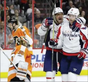  ?? MATT SLOCUM — THE ASSOCIATED PRESS ?? Washington Capitals center Nicklas Backstrom (19) celebrates his first-period goal with teammate Alex Ovechkin as the Capital went on to a 4-1 victory over the Flyers on Wednesday.