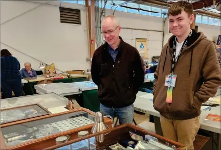  ?? ANDREA GRAJEDA — STAFF WRITER ?? Grant Dickson, left, and his son Wilson Leech-dickson stand in front of their coin collection at the Front Range Coin Club show at the Boulder County Fairground­s on Sunday.