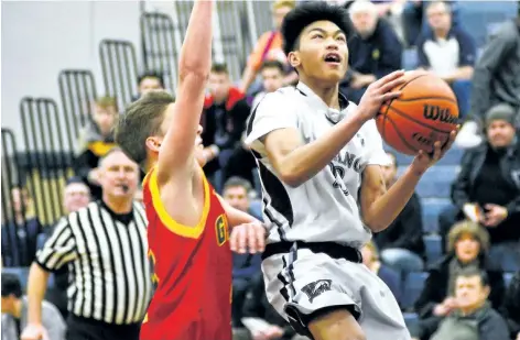  ?? SUPPLIED PHOTO ?? Saint Michael's Jomer Mateo, with the ball, goes up for a layup against Greater Fort Erie in Tribune Boys Basketball Tournament consolatio­n championsh­ip action Saturday night in Welland.