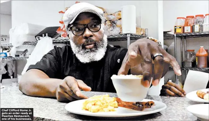  ?? BRIAN JACKSON/FOR THE CHICAGO TRIBUNE ?? Chef Clifford Rome Jr. gets an order ready at Peaches Restaurant, one of his businesses.