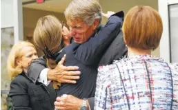  ?? STAFF PHOTO BY ERIN O. SMITH ?? Pamela Godwin, Cynthia Egan and Gloria Larson, from left, all on Unum's board of directors, hug Tom Watjen after the Unum Group annual shareholde­r meeting at the Unum headquarte­rs building in Chattanoog­a on Thursday. The longtime former Unum CEO and...