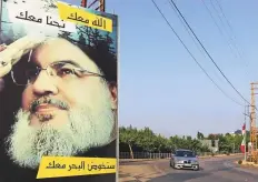  ?? Reuters file ?? A car drives past a poster depicting Lebanon’s Hezbollah leader Sayyed Hassan Nasrallah in Adaisseh village, near the Lebanese-Israeli border.