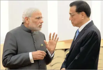  ?? PHOTO: AP ?? Indian Prime Minister Narendra Modi (left) talks with Chinese Premier Li Keqiang at the Great Hall of the People in Beijing, China. The author says Modi’s strategy to navigate the impossible trinity of the US, China and Europe-Russia has three core...