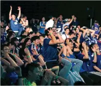  ?? AP ?? Japanese supporters react in frustratio­n at a public viewing venue in Tokyo after their team lost to Belgium. —