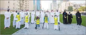  ??  ?? Officials and dignitarie­s with children during the tree-planting event at Al Shoura Plaza.