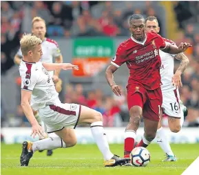  ??  ?? Burnley defender Ben Mee tries to dispossess Daniel Sturridge