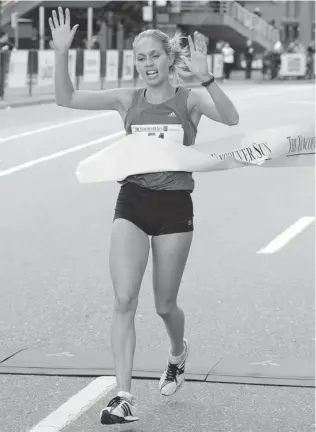  ?? LYLE STAFFORD/ VANCOUVER SUN ?? Natasha Fraser crosses the finish line first in the women’s division at the 2012 Vancouver Sun Run. She comes into this year’s run in great shape and hopes to successful­ly defend her title.