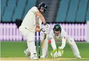  ?? /AFP ?? In control: Dawid Malan plays a shot as Cricket Australia XI’s wicketkeep­er Tim Paine looks on