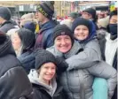  ?? DAVE STRUETT/SUN-TIMES ?? Irene Pacocha and her children Dylan and Morgan came from Lincoln Square to view the Lunar New Year parade in Chinatown.