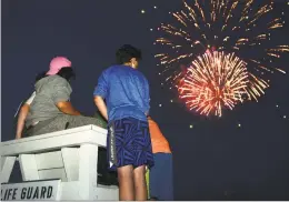  ?? Erik Trautmann / Hearst Conn. Media ?? Here and far left, locals gather for the annual fireworks show at Calf Pasture 2018 in Norwalk on July 3, 2019.